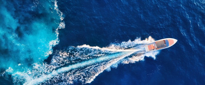 Croatia. Yachts at the sea surface. Aerial view of luxury floati Aerial view of a speedboat creating a white wake on vibrant blue ocean water.